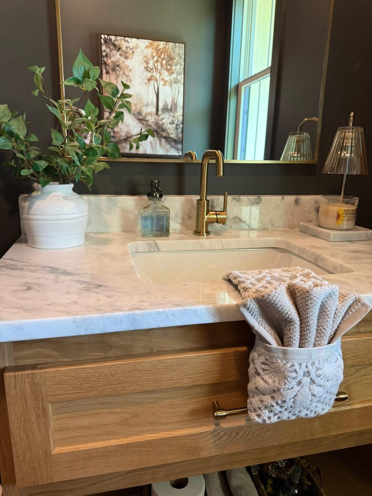Clean marble vanity with gold fixtures